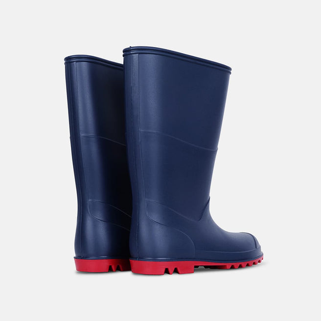 Two Classic Wellies Navy stand side-by-side, facing away. The wellies are navy blue with red soles.